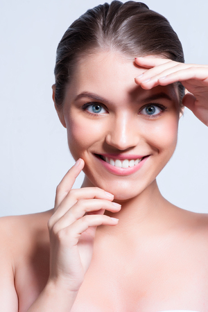 Woman beauty face portrait isolated on white with healthy skin.の写真素材