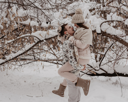 Happy Young Couple in Winter Park having fun.Family Outdoors. love.の写真素材
