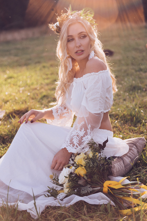 Bride. Boho bride with wreath on sunset outdoor. Boho style.の写真素材