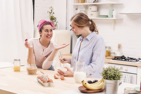 Two cheerful friends cook together. Friends Chef Cook Cooking Concept.の写真素材