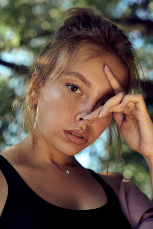 portrait of cute beautiful young girl with freckles close-upの写真素材