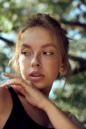 portrait of cute beautiful young girl with freckles close-upの写真素材