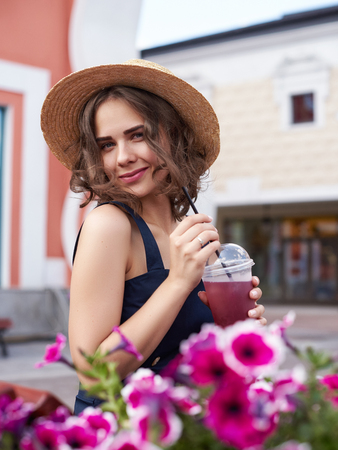 Summer sunny lifestyle fashion portrait of young stylish hipster woman walking on the street, wearing cute trendy outfit,の写真素材