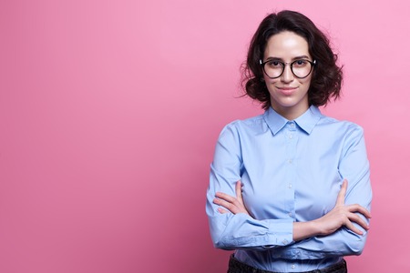 Studio shot of good looking intelligent female professor, have no much experience, wears big round spectacles. Caucasian college student recieves good proposalの写真素材