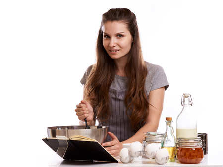 Portrait of beautiful chef home cook at home with dessert cupcakes homemade sweets.の写真素材