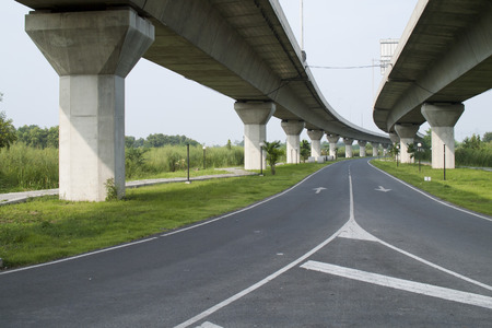 Empty asphalt road under the new expressway line.