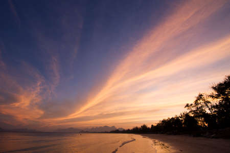 late summer dawn with a cloudy and warm skyの写真素材