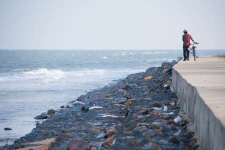man with a bicycle on the beachの写真素材