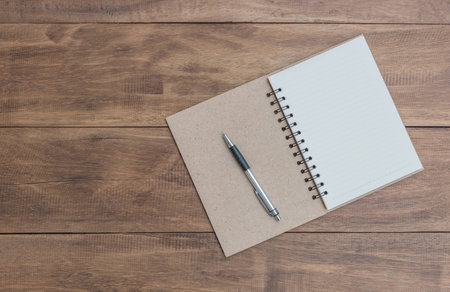 Open a blank notebook and pen on the tableの写真素材