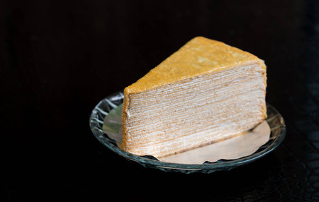 Delicious tea cake on plate on black tableの写真素材