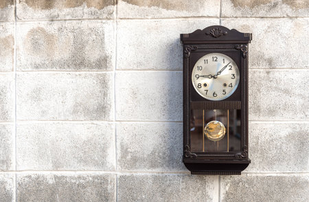 Antique wall clock with a pendulumの写真素材
