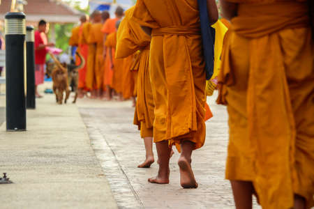 Giving to aims of thai monks  Thailand merit to the early days of Buddhist monks  At Nongkhai City, North East of Thailand のeditorial素材