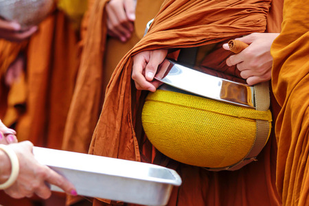 Giving to unidentified monksの写真素材