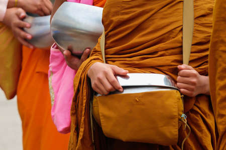 Giving to unidentified monksの写真素材