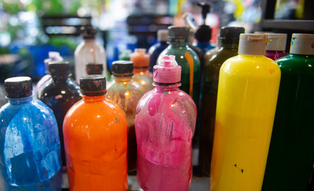 Colorful plastic bottles for paint in a shop, close-upの写真素材