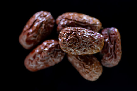 Dates on a black background. Close-up, selective focus.の写真素材