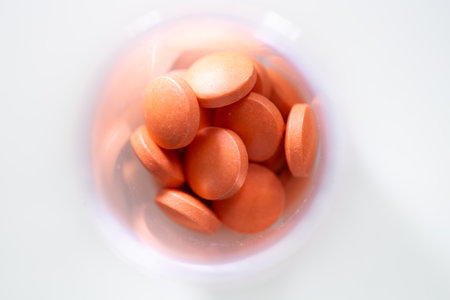 Orange pills on a white background. Shallow depth of field.の写真素材