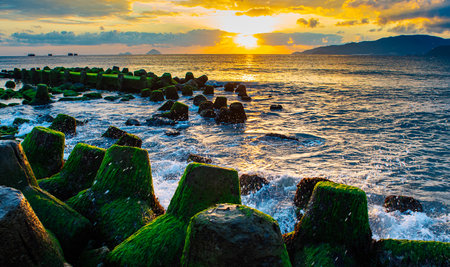 In the foreground, concrete breakwaters stand strong, protecting theの写真素材