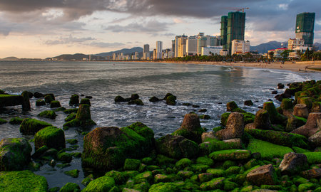 Nha Trang is a stunning coastal city known for its sandy beaches and vibrant marine life. In the foreground, concrete breakwaters stand strong, protecting theの写真素材