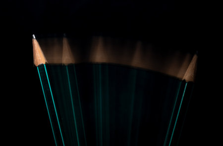 Close-up of sharpened pencils on a black background.の写真素材