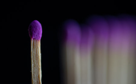 Purple matchstick on a black background. Close-up.の写真素材