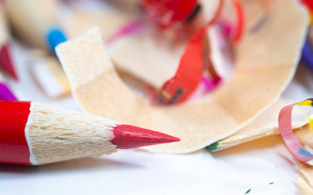 Colored pencils with sharpening shavings on white backgroundの写真素材