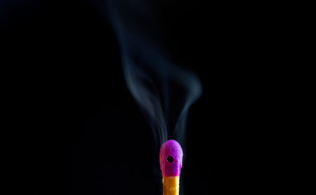 Matchstick with smoke on black background. Close-up image.の写真素材