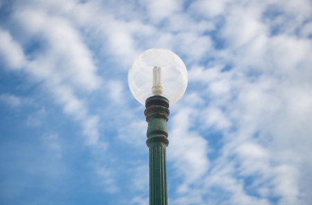 Lamp post with blue sky and white cloud background, Thailand.