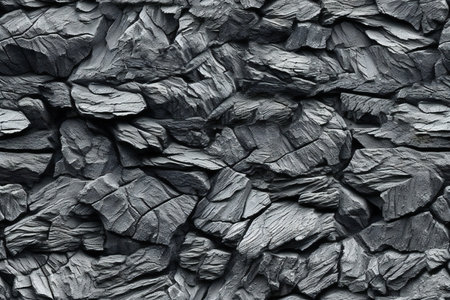 Background of black slate stone wall texture. Black and white photo.の素材