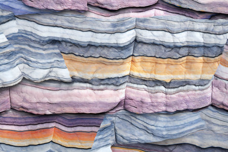 Colorful sandstone rock texture background, closeup of photo.の素材