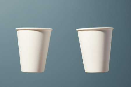 White paper coffee cup on blue background.の素材