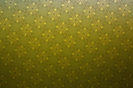 Close up of a yellow and white pattern on a green background.