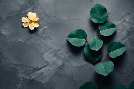 Green leaves and flowers on grey background. Flat lay, top viewの素材