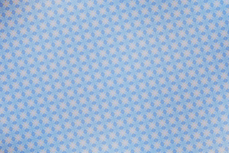 Blue fabric with white snowflakes on it. High quality photoの写真素材
