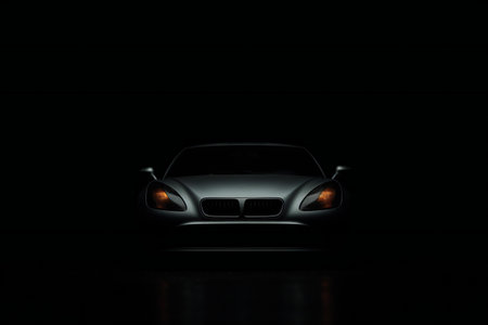 Front view of a luxury sports car on a dark background with backlightの素材