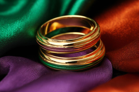 Wedding rings on a background of multicolored satinの素材