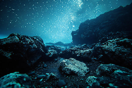 Underwater view of the dark sea with rocks and starry skyの素材