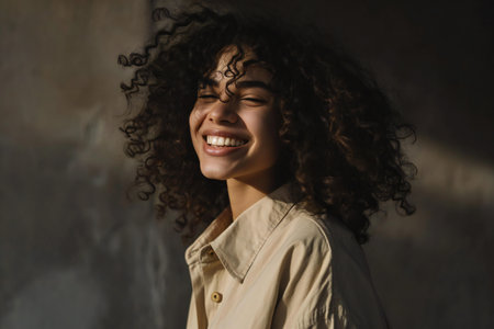 Portrait of a smiling young african american woman with curly hairの素材