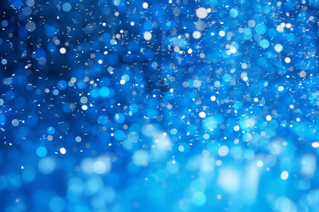 abstract blue bokeh background with glitter defocused lights and starsの素材
