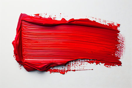 Red paint brush stroke on white paper background with copy space for textの素材