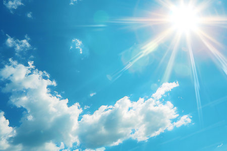 Blue sky background with tiny clouds and bright sun. Beautiful nature scene.の素材