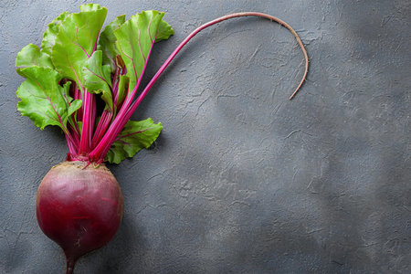 Fresh beetroot with leaves on grey textured background, top viewの素材