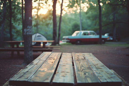 Wooden table in the park at sunset, vintage color tone.の素材