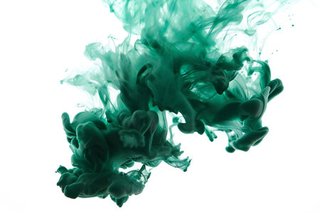 Green ink in water on a white background. Abstract background for design.の素材