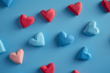 Colorful hearts on blue background, valentine's day conceptの素材