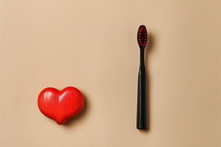 Toothbrush and red heart on a brown background, top viewの素材
