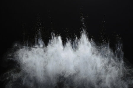 White powder explosion isolated on black background. Abstract white cloud texture.の素材