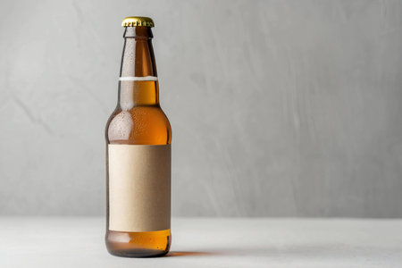 Beer bottle with blank label on grey background. Mockup for designの素材
