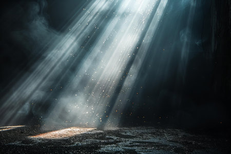 Light in the cave. Dark mysterious dark room with light rays and smokeの写真素材