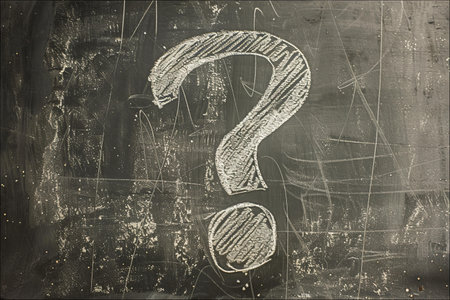 Question mark on a blackboard. Question mark drawn in chalk.